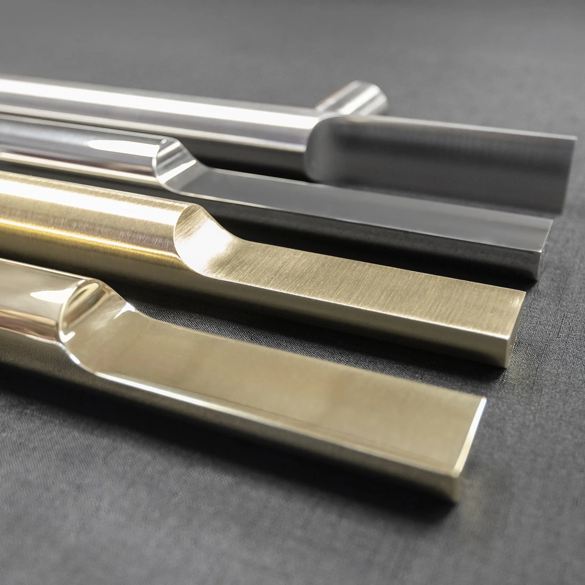 multiple-canoe-style-handrail-finishes-in-brass-and-stainless-brushed-and-mirror-finishes