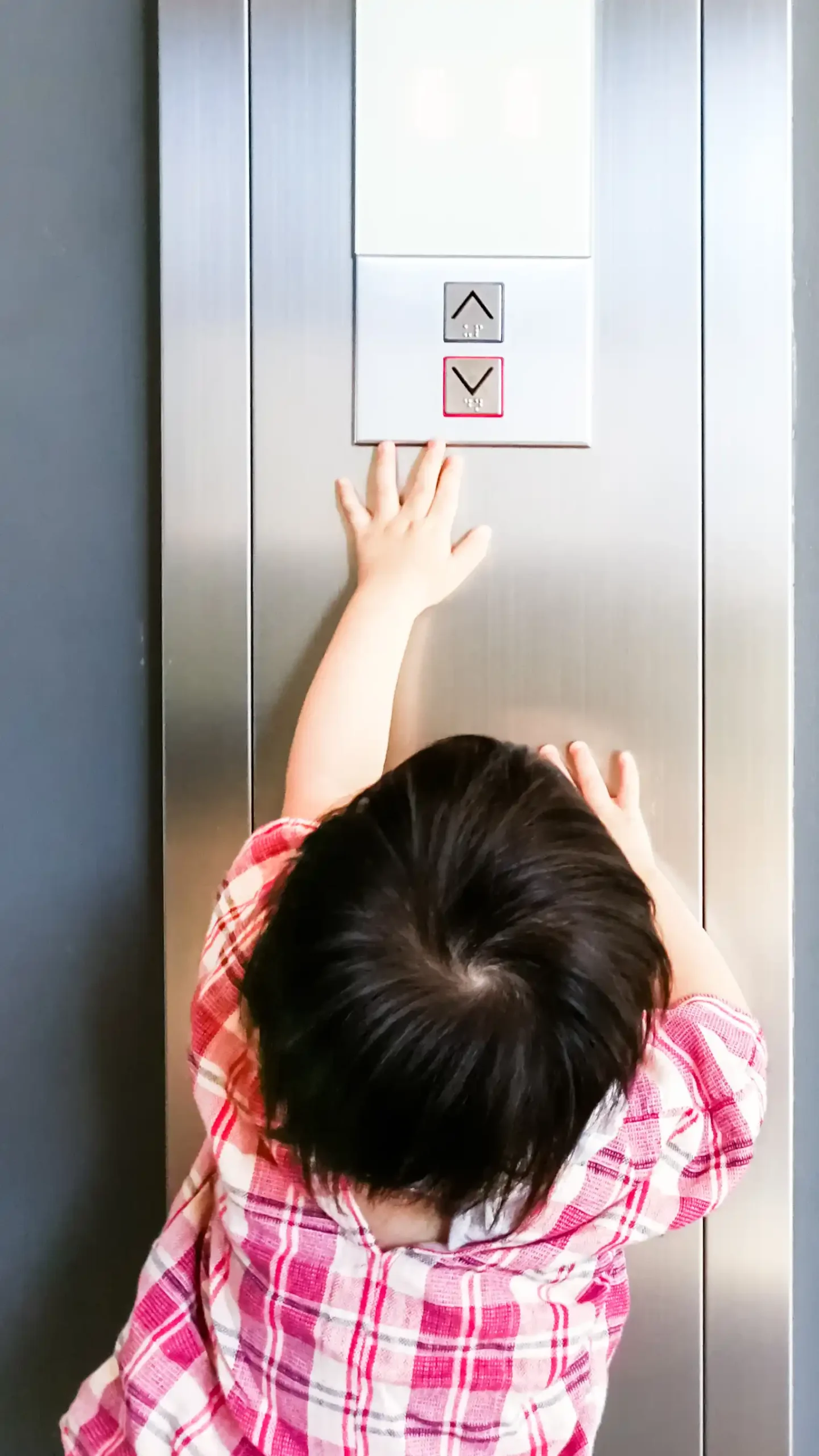 young-architectural-elevator-design-client-pushing-elevator-call-button-1-scaled