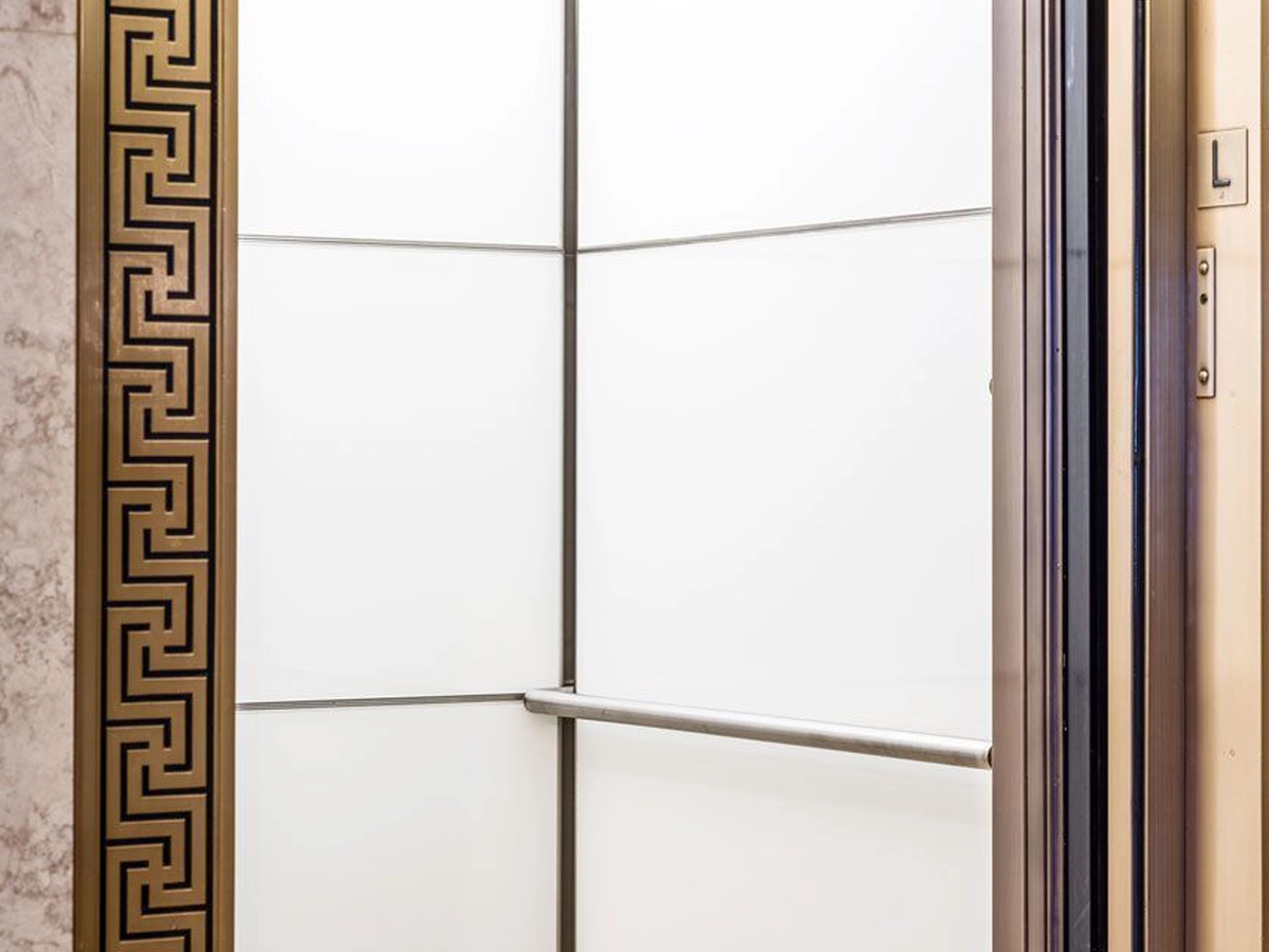 boston-series-elevator-interior-backpainted-white-glass-bronze-surrounds-7-d-m