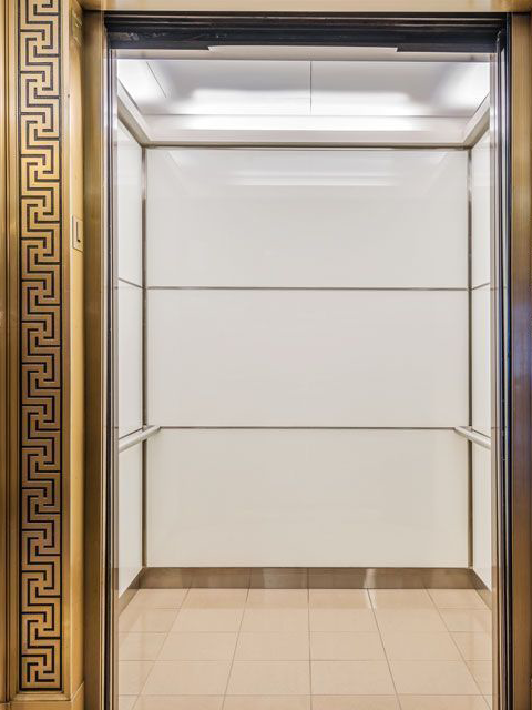 boston-series-elevator-interior-backpainted-white-glass-bronze-surrounds-1