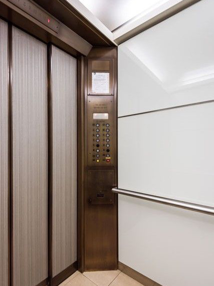 boston-series-elevator-interior-backpainted-white-glass-bronze-surrounds-3