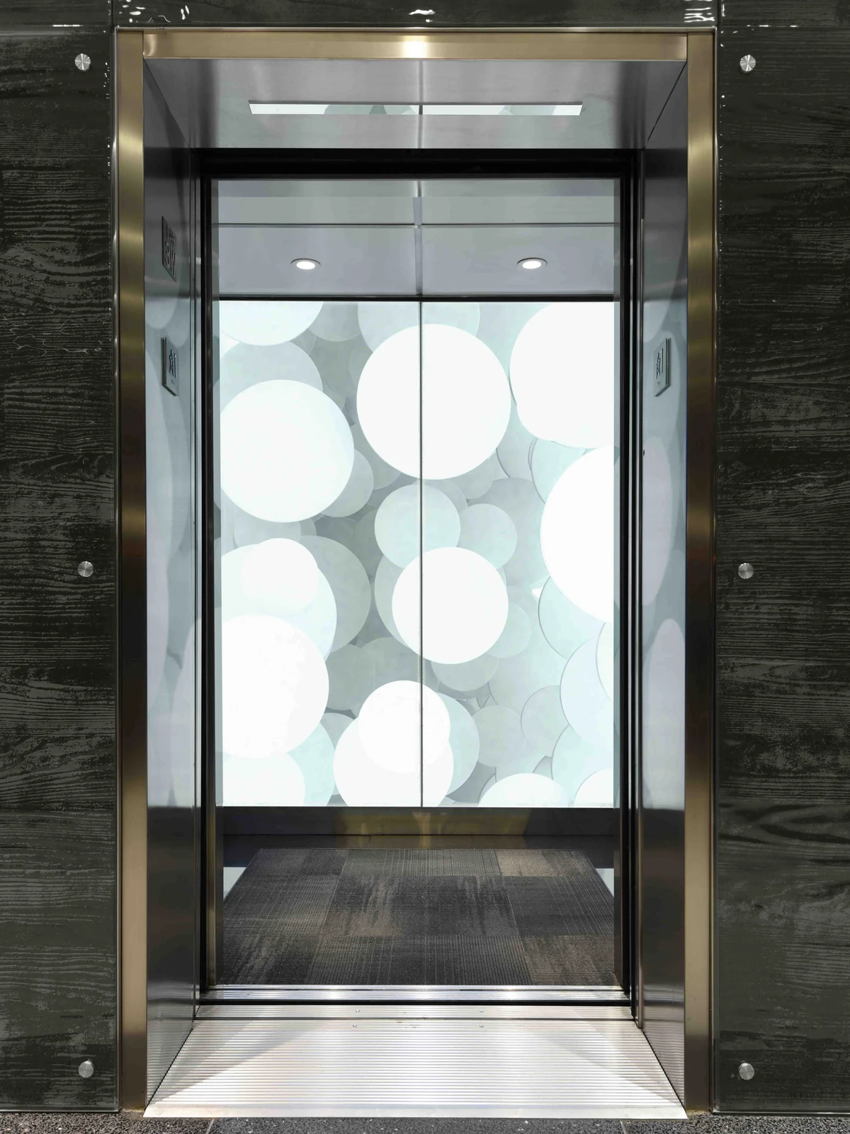 seattle-series-elevator-interior-backlit-glass-abstract-circles-image-1