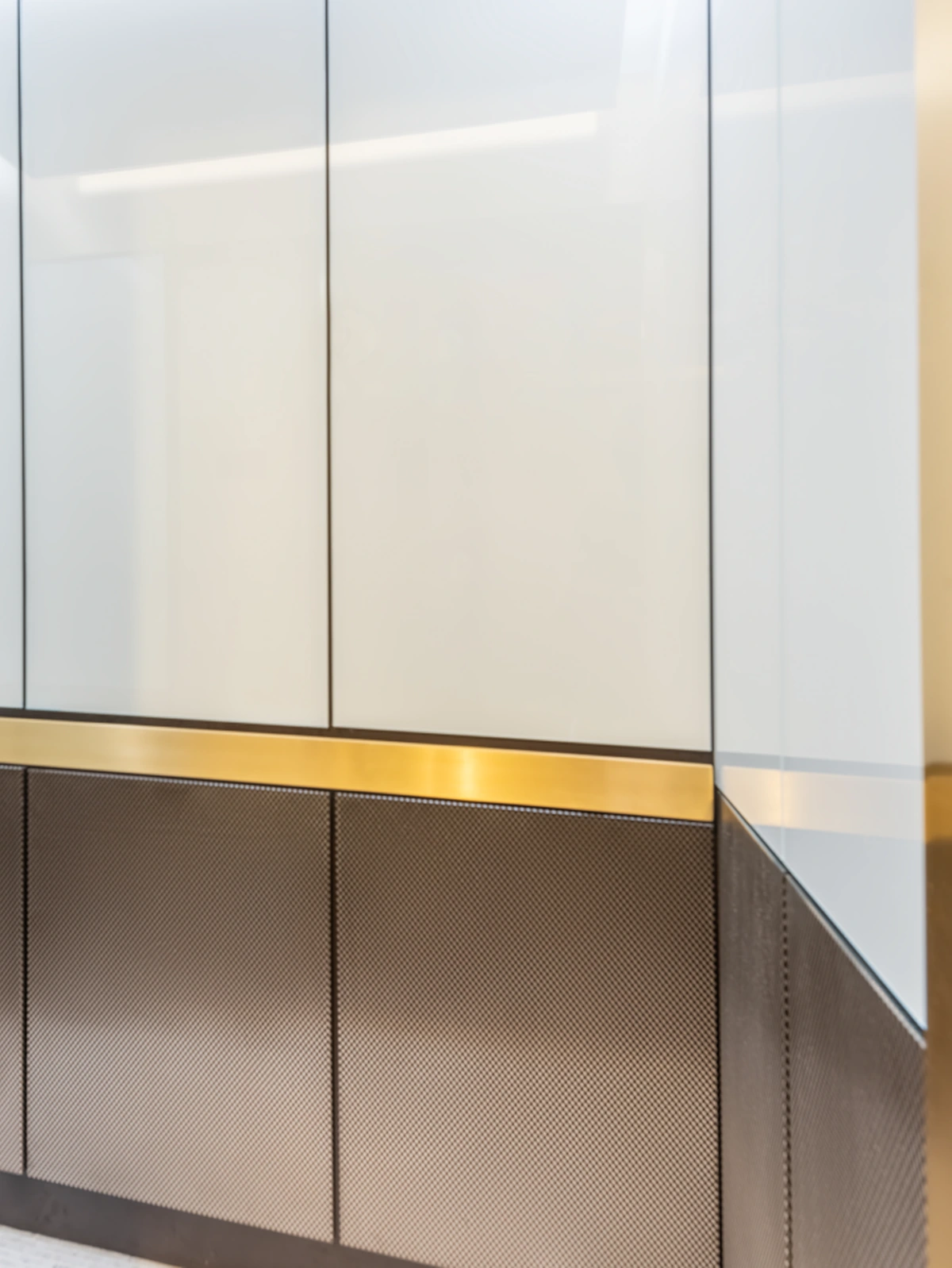 Berlin Series luxury elevator cab interior — white back-painted glass with brass handrail