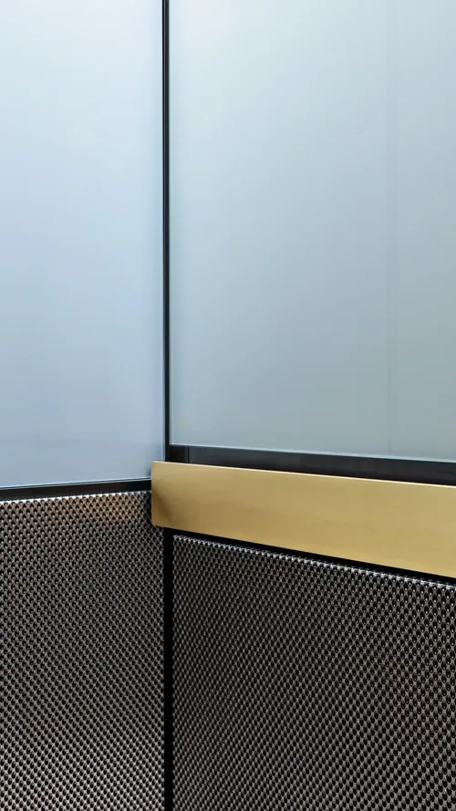 Berlin Series luxury elevator interior — white glass and patterned stainless